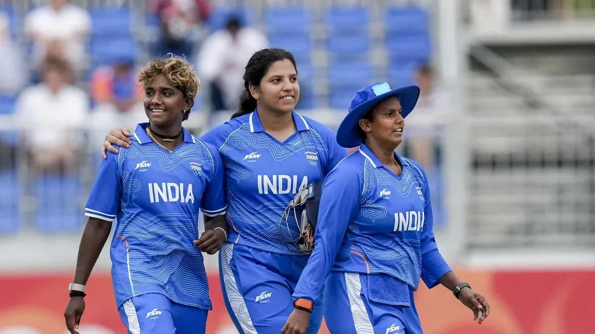 Three Indian women cricketers walking on field
