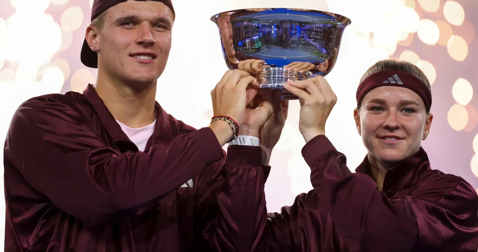 Athletes celebrating victory with trophy in hand