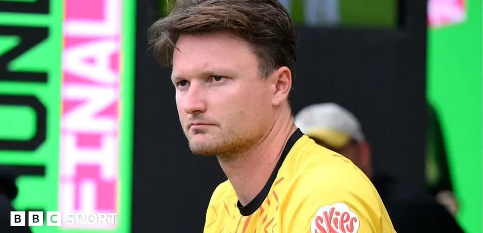 Goalkeeper in yellow jersey sitting on bench
