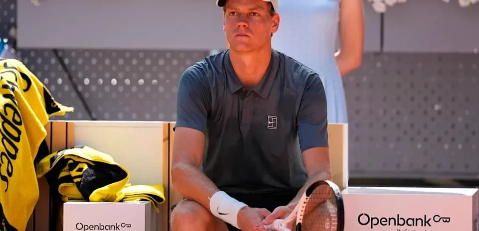 Tennis player sitting on bench during match break