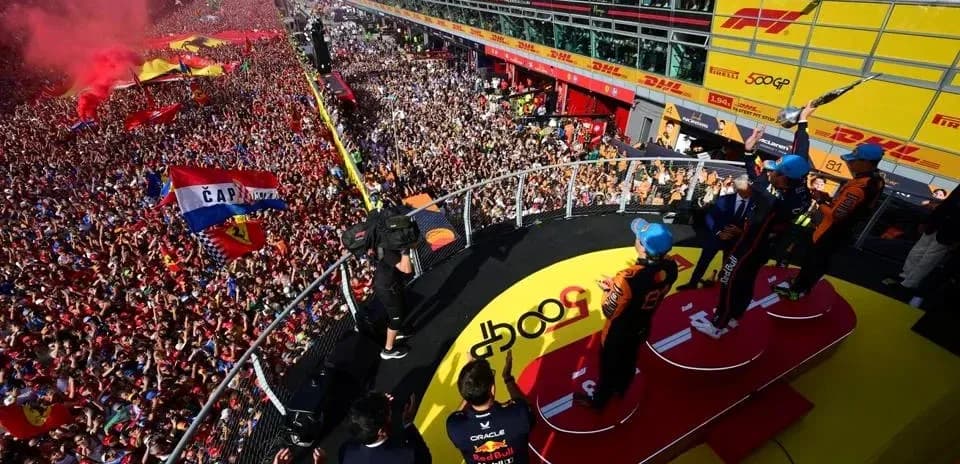 Podium celebration with drivers and cheering crowd
