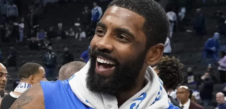Player smiling after game, wearing blue jersey