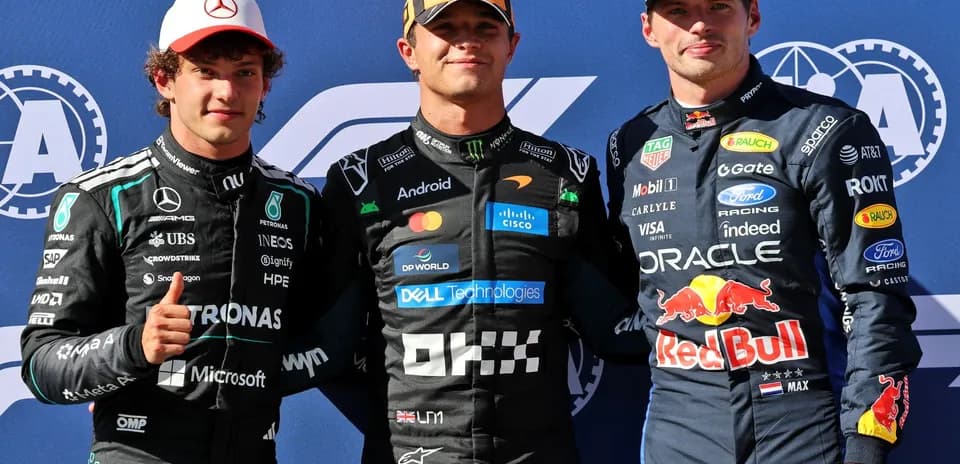 Three Formula 1 drivers posing at podium ceremony