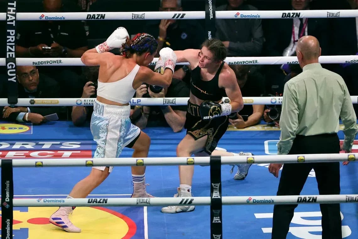 Two female boxers exchanging punches in the ring
