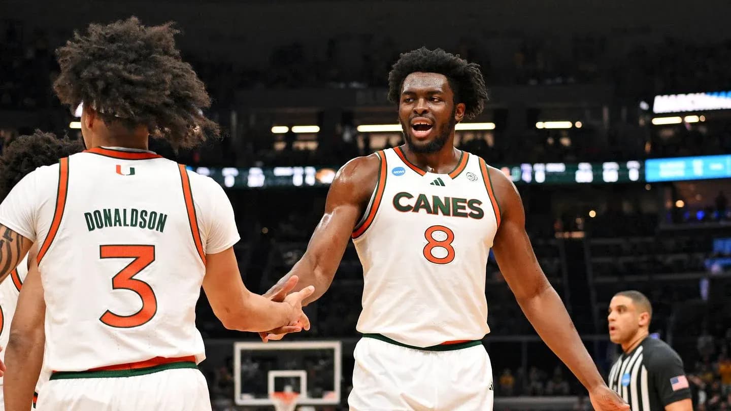 Two Miami players celebrating during a basketball game