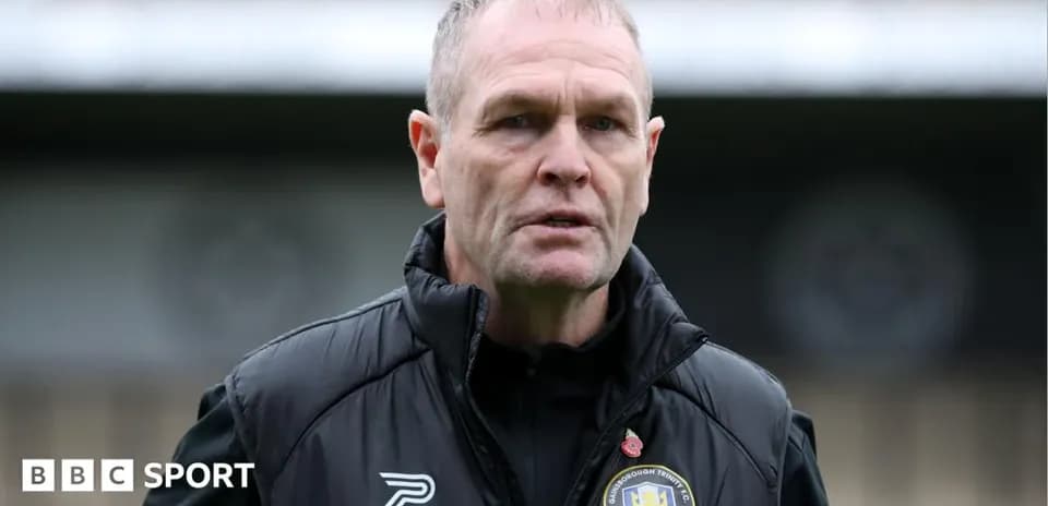 Manager wearing club jacket at training ground