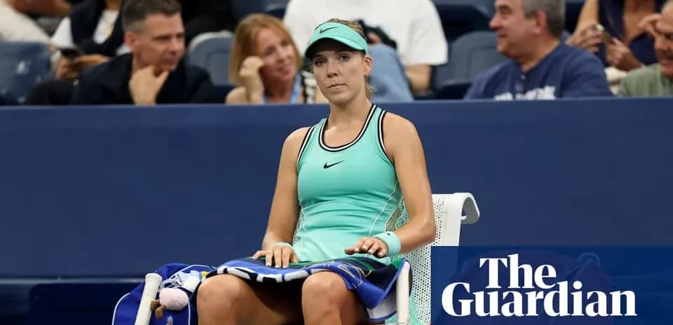 Tennis player seated on bench during match break