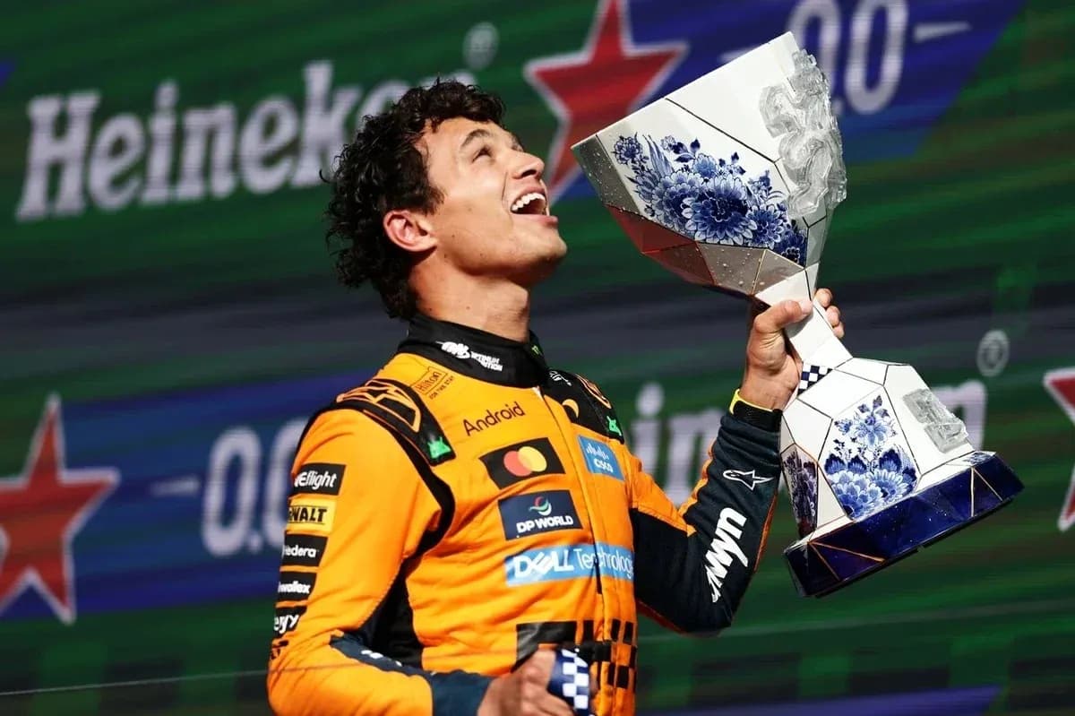 Driver celebrating with trophy on podium