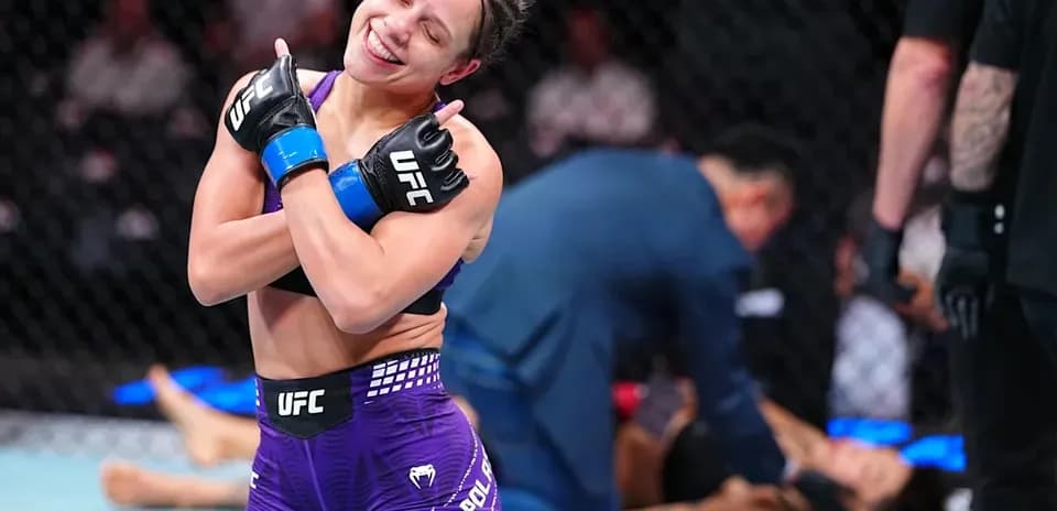 Fighter celebrating victory in the octagon after match