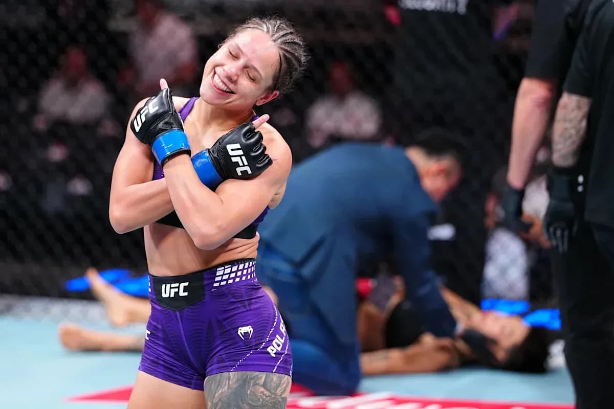 Fighter celebrating victory in the octagon after match