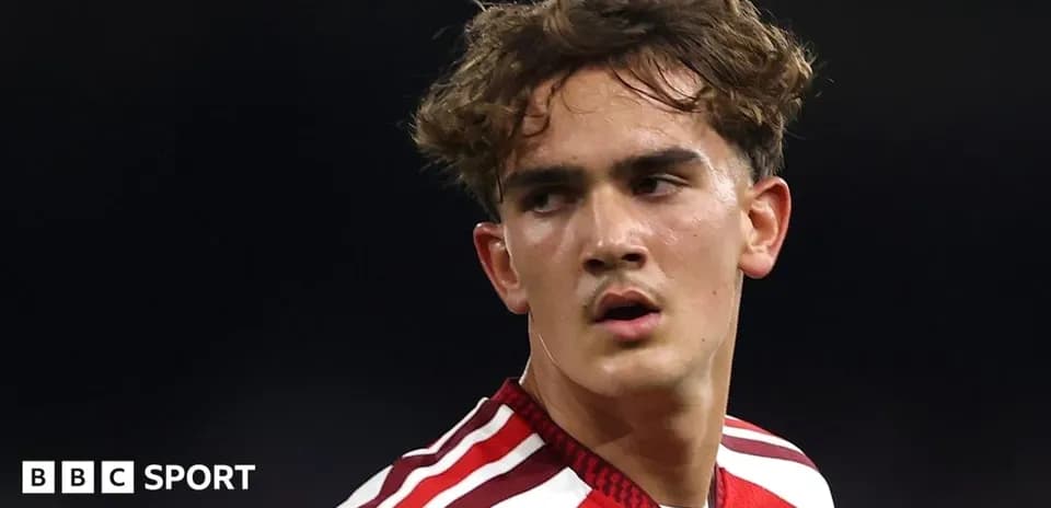 Young player in red jersey during match