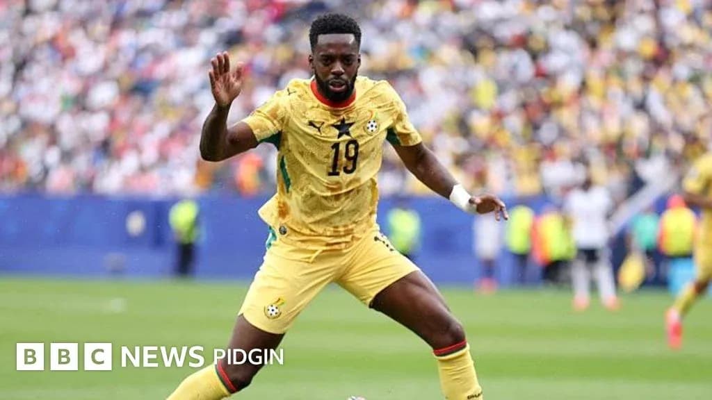 Ghana player in yellow kit during match action