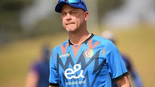 Coach observing players during training session