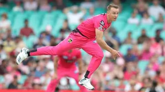 Bowler delivering a ball during cricket match