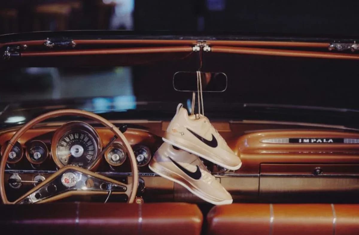 Nike sneakers hanging from vintage car dashboard