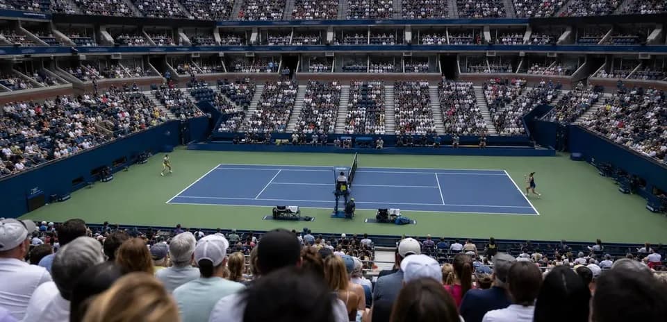 Tennis match in progress with large crowd watching