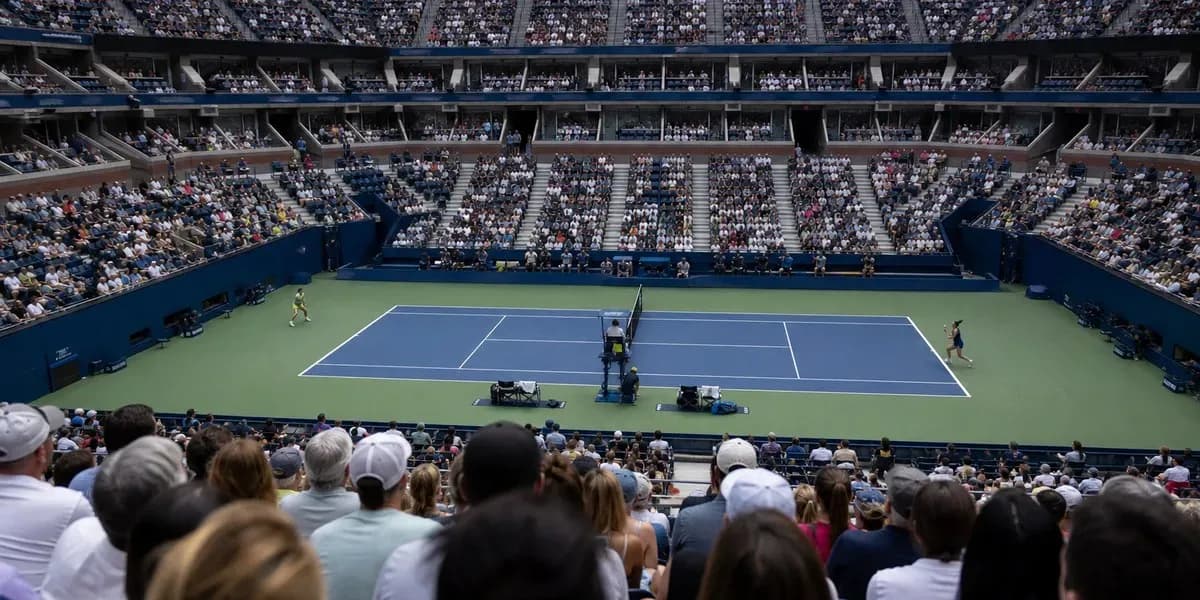 Tennis match in progress with large crowd watching