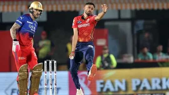 Bowler delivering a ball while batsman stands ready