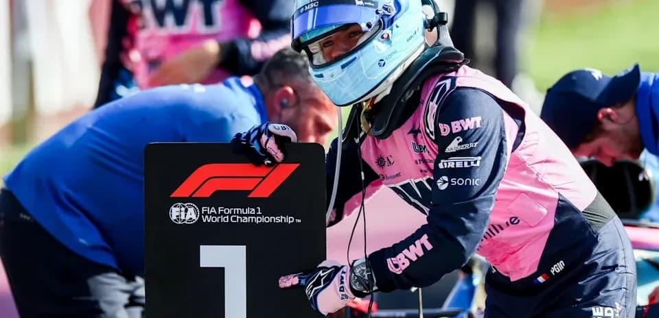 Driver holding first place sign during Formula 1 event