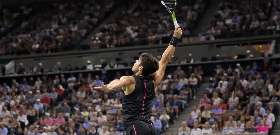 Tennis player serving during a match with crowd