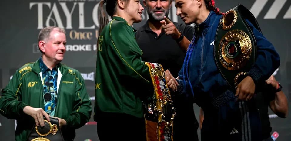 Boxers shaking hands at press conference with belts