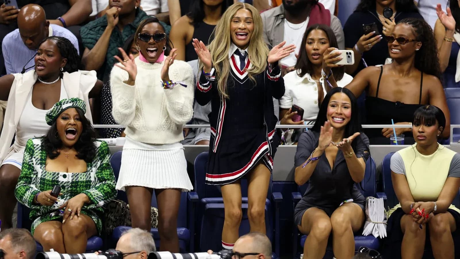 Fans cheering enthusiastically at tennis match