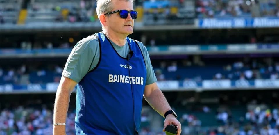 Coach walking on field during match warm-up