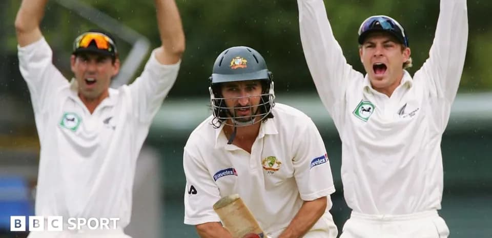 Batsman in action with fielders celebrating appeal