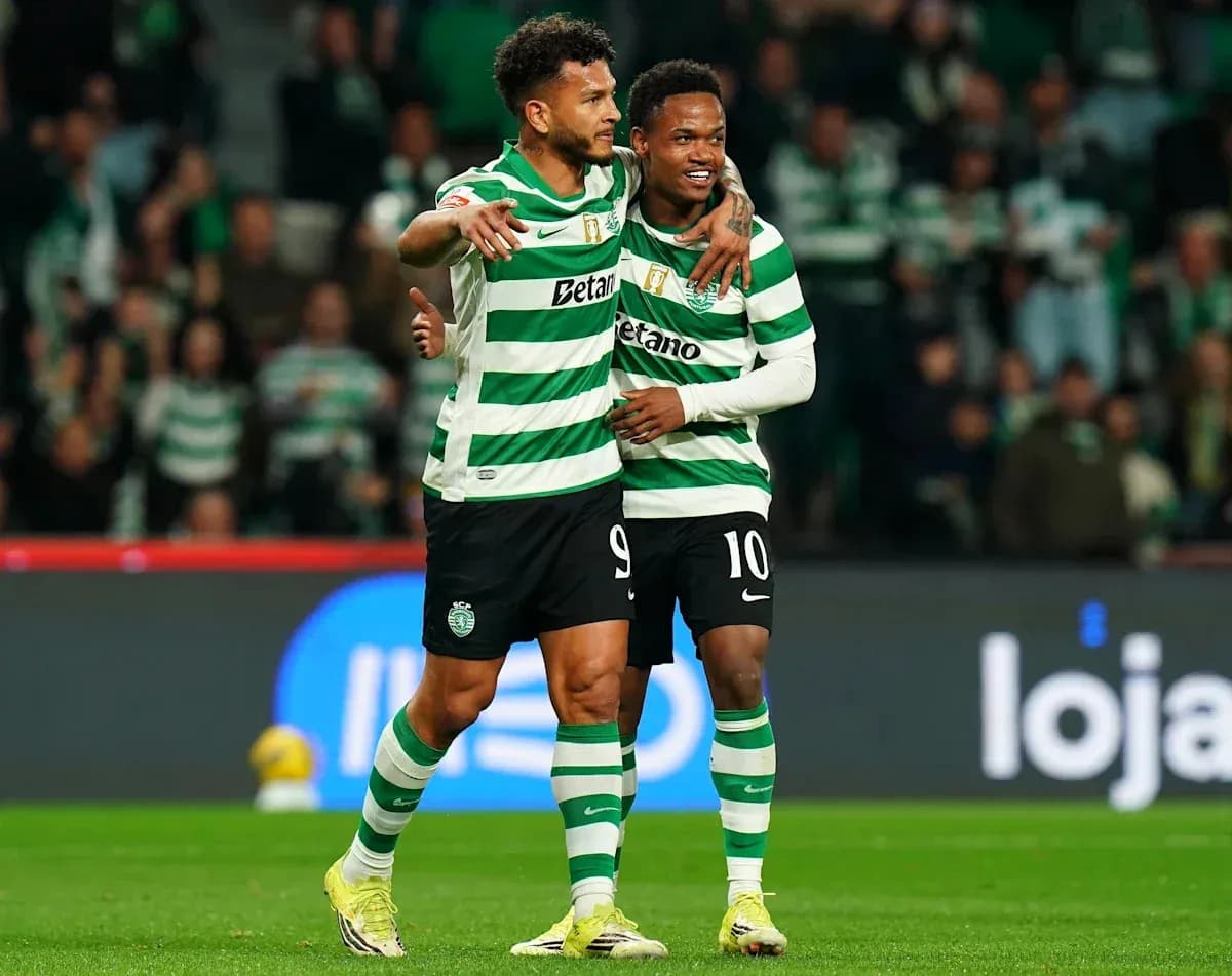 Two players celebrating on the pitch in striped jerseys