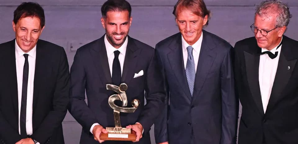 Four men posing with an award at an event