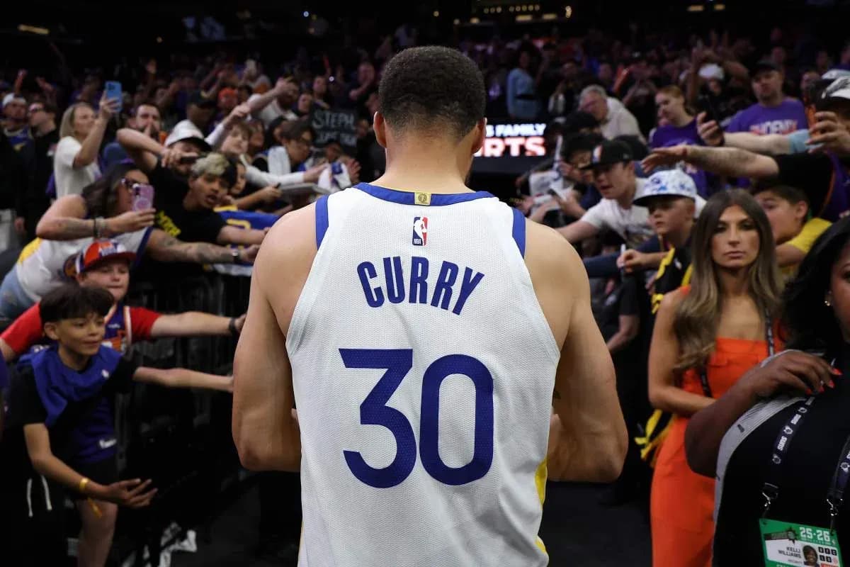 Player in jersey walking past enthusiastic fans