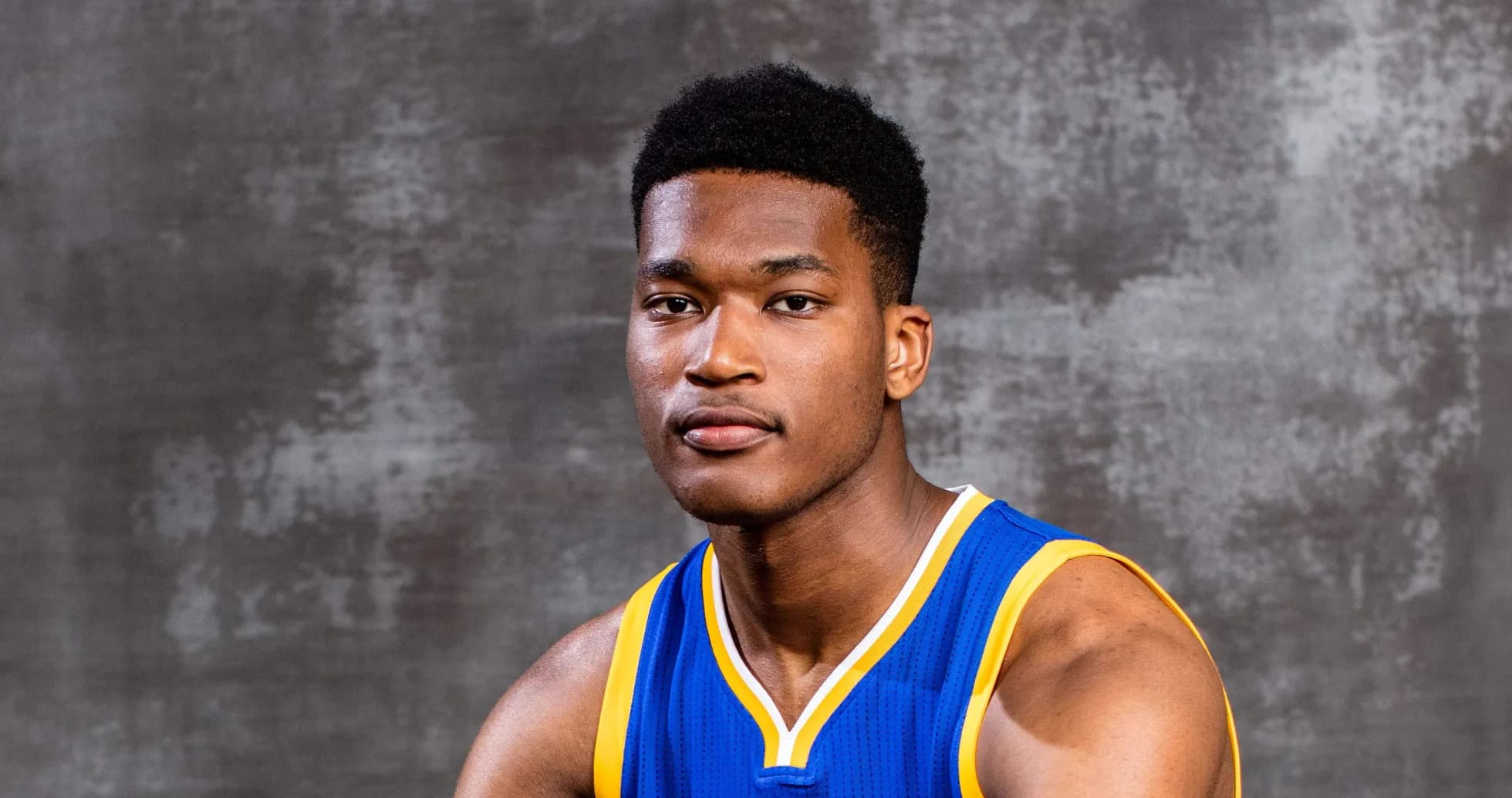 Basketball player in blue jersey posing for photo