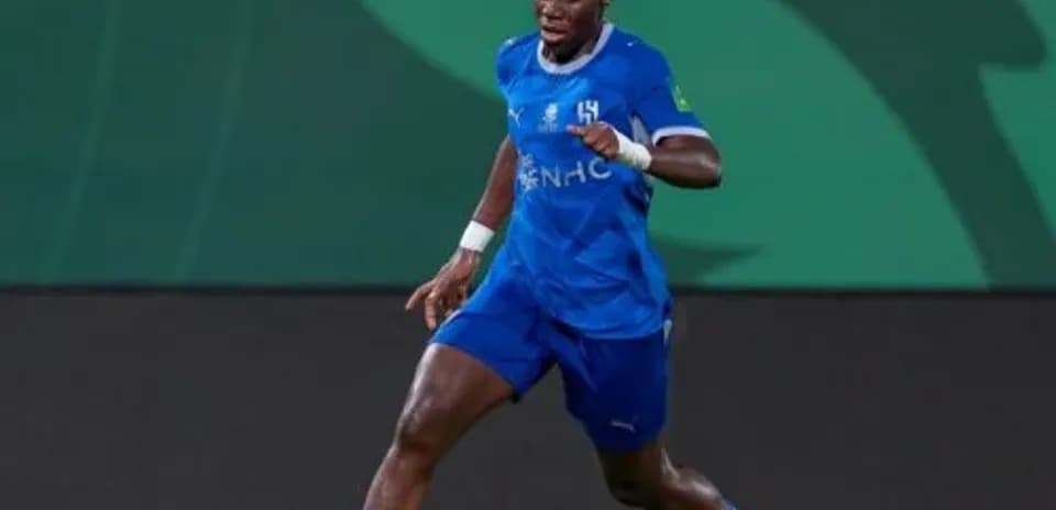 Player in blue kit dribbling the ball on field