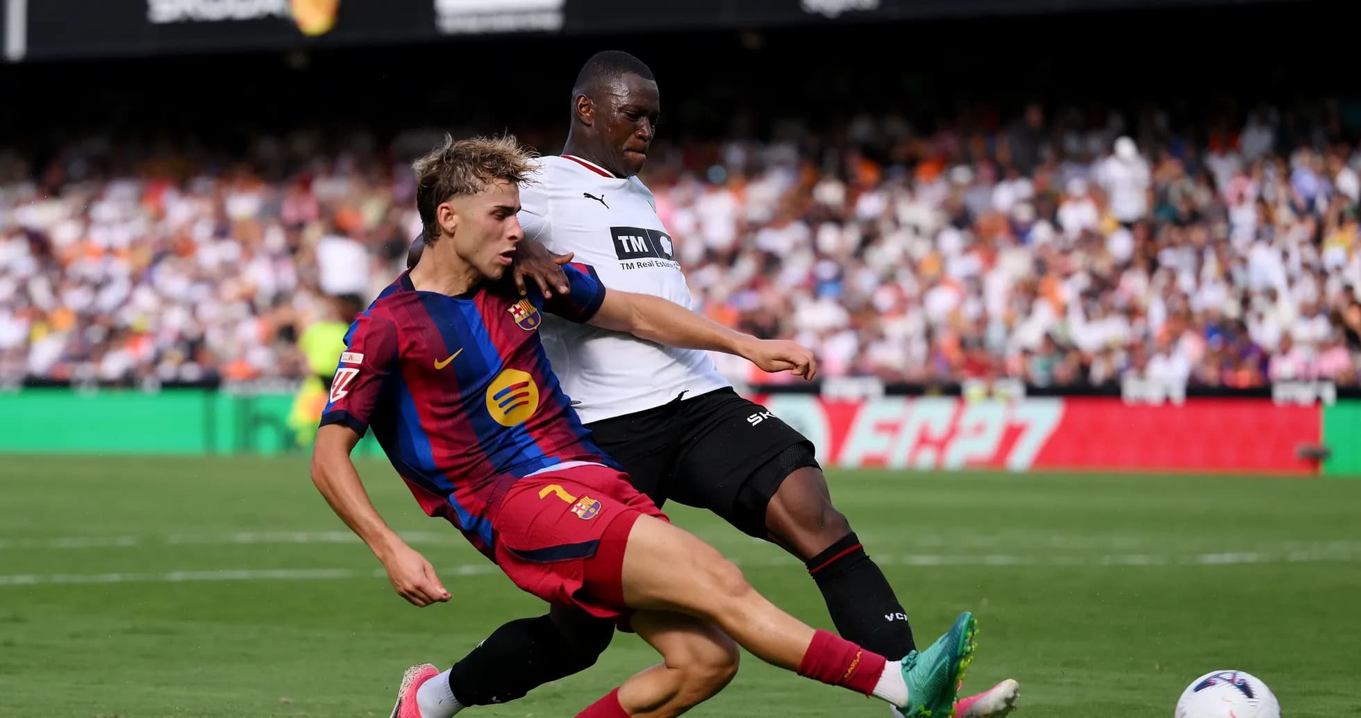 Barcelona player tackles opponent during match