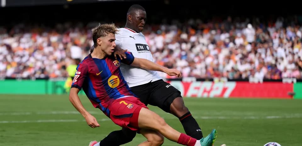 Barcelona player tackles opponent during match