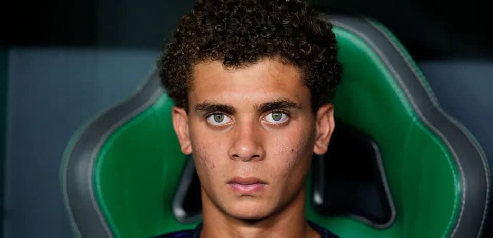 Young athlete sitting in a sports chair, looking serious