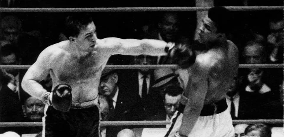 Boxers exchanging punches in a boxing match