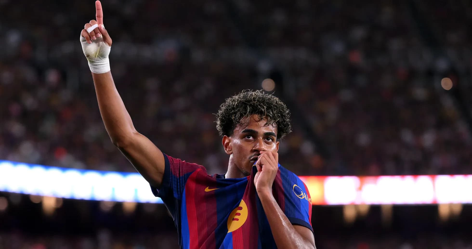 Player celebrating and kissing club jersey during match