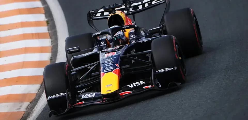 Formula 1 car racing around a curved track