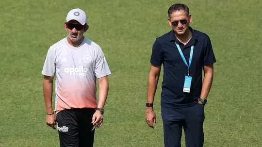 Two coaches walking on the training field