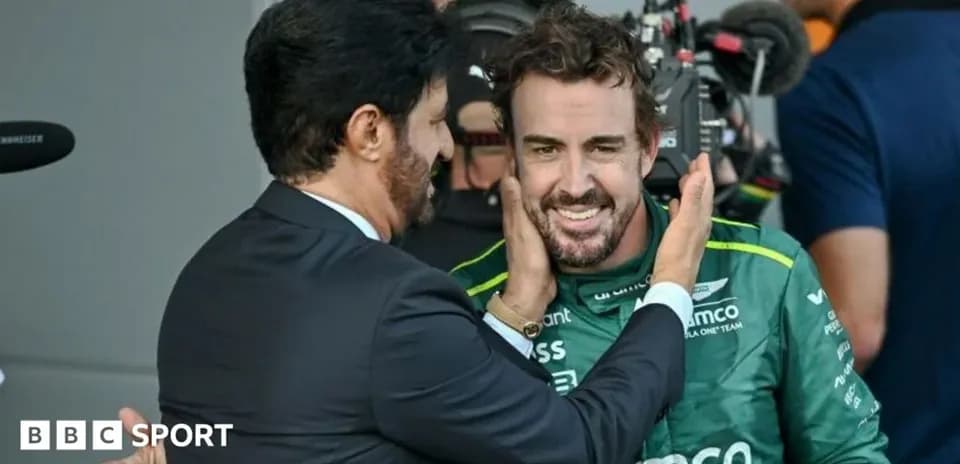 Fernando Alonso interacting with team representative post-race