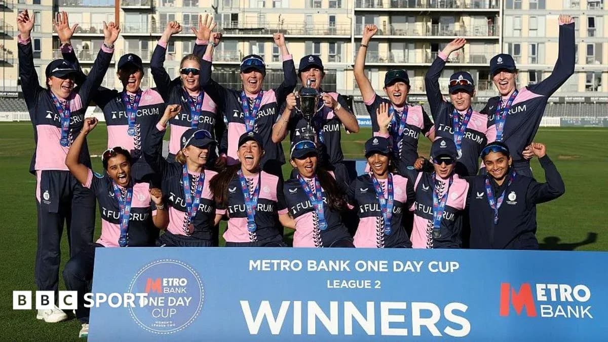 Cricket team celebrating victory with trophy and medals