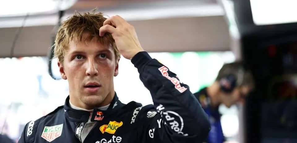 Driver adjusting hair in pit area before race
