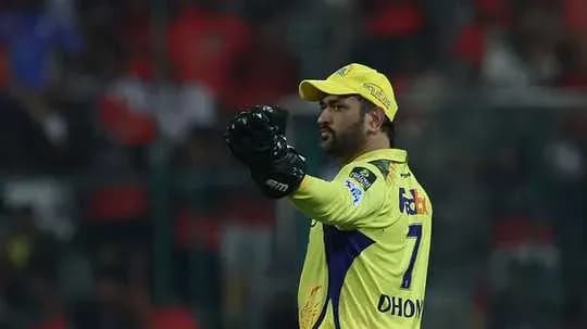 Cricket player in yellow jersey signaling during match
