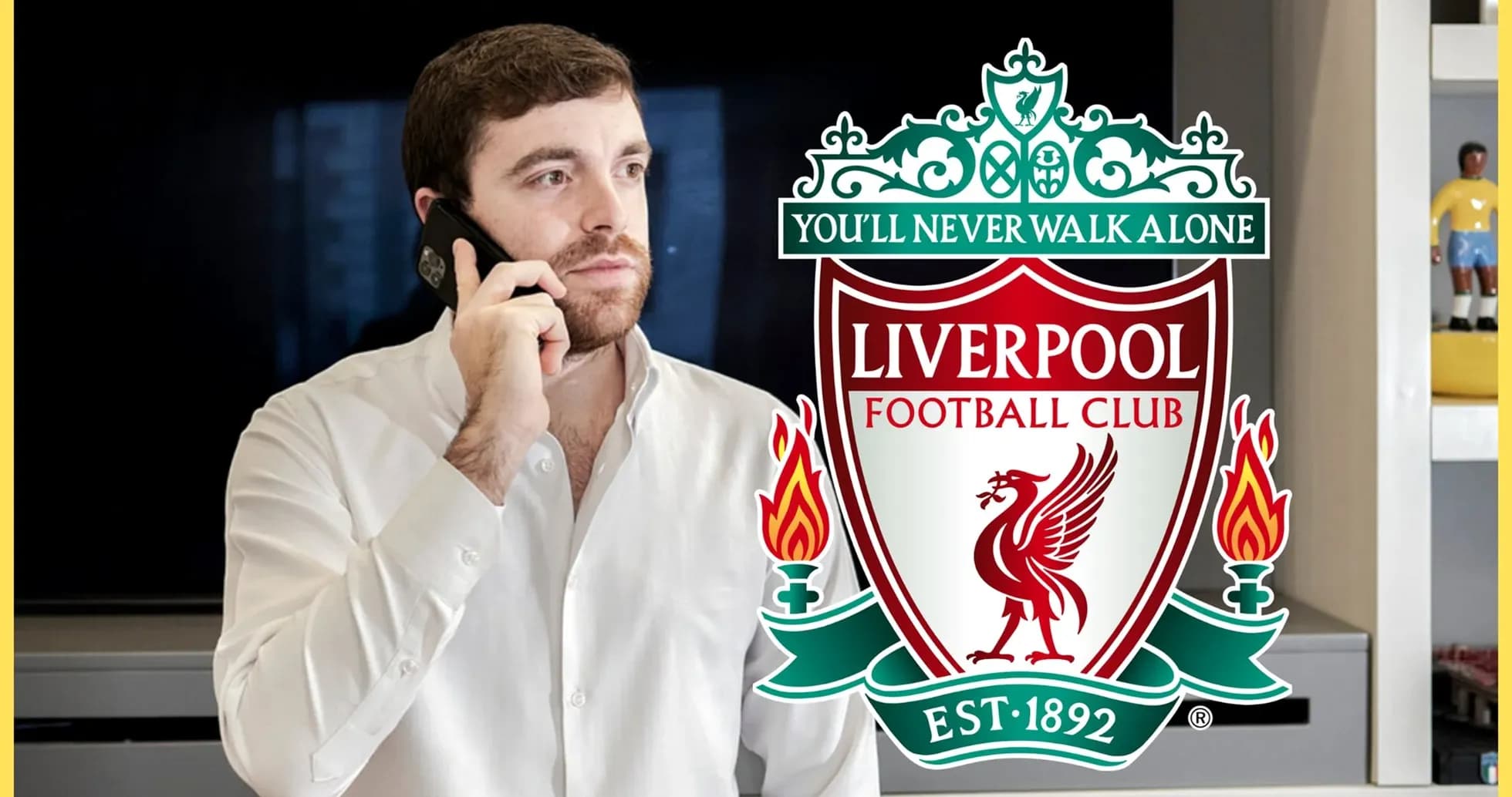 Man talking on the phone with Liverpool FC logo