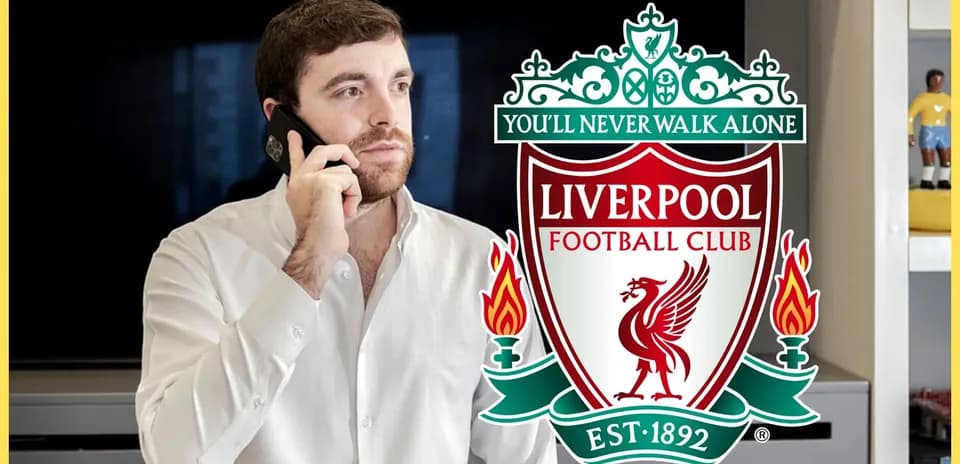 Man talking on the phone with Liverpool FC logo