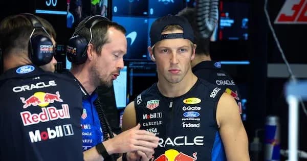 Team members discussing strategy in the pit area