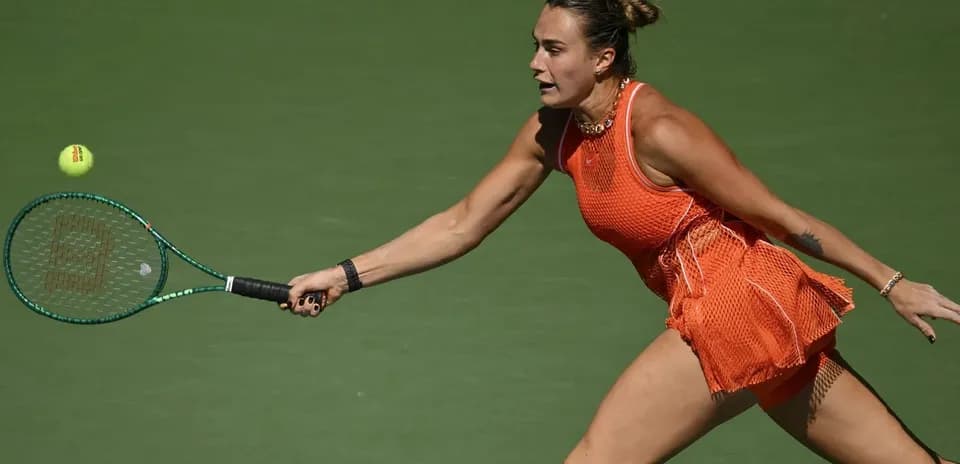 Player reaching for a tennis ball during match