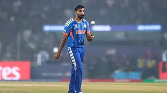 Bowler in India jersey preparing to bowl