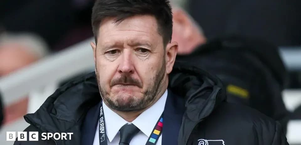 Manager wearing Derby County jacket on sidelines